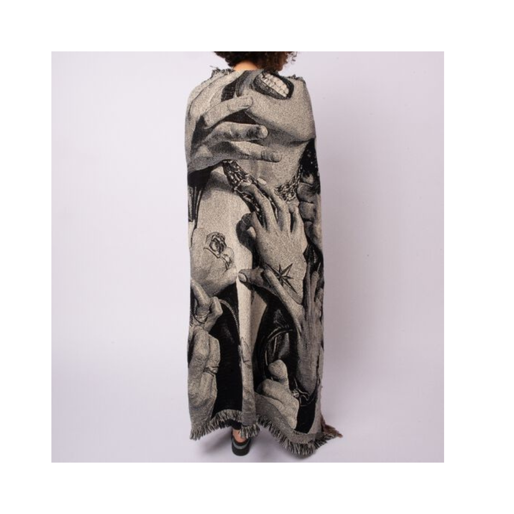 Blanket or shawl with a striking black and white photorealistic design depicting hands and body parts.